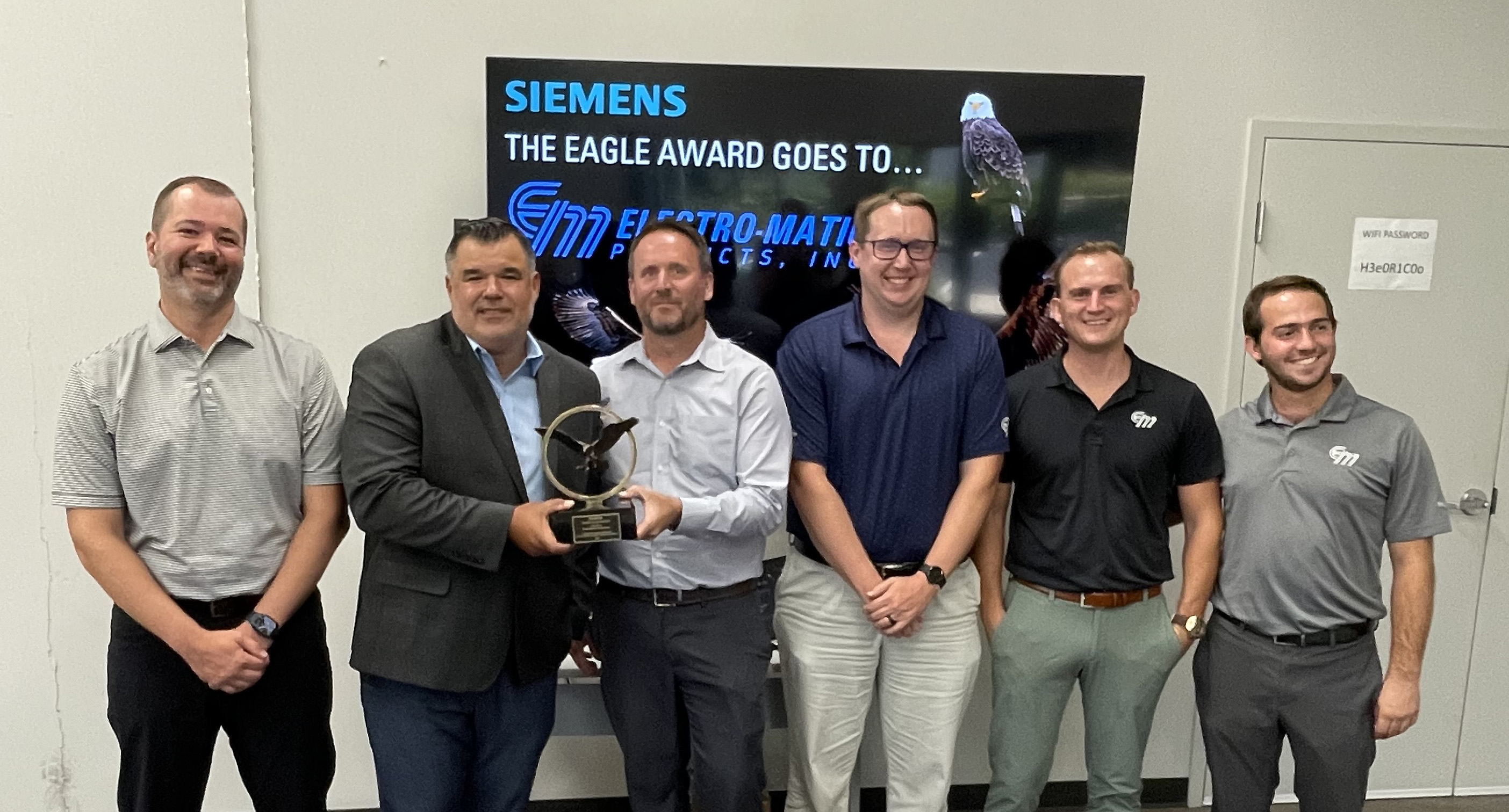 Electro-Matic's executives and Florida team members accepting the award.