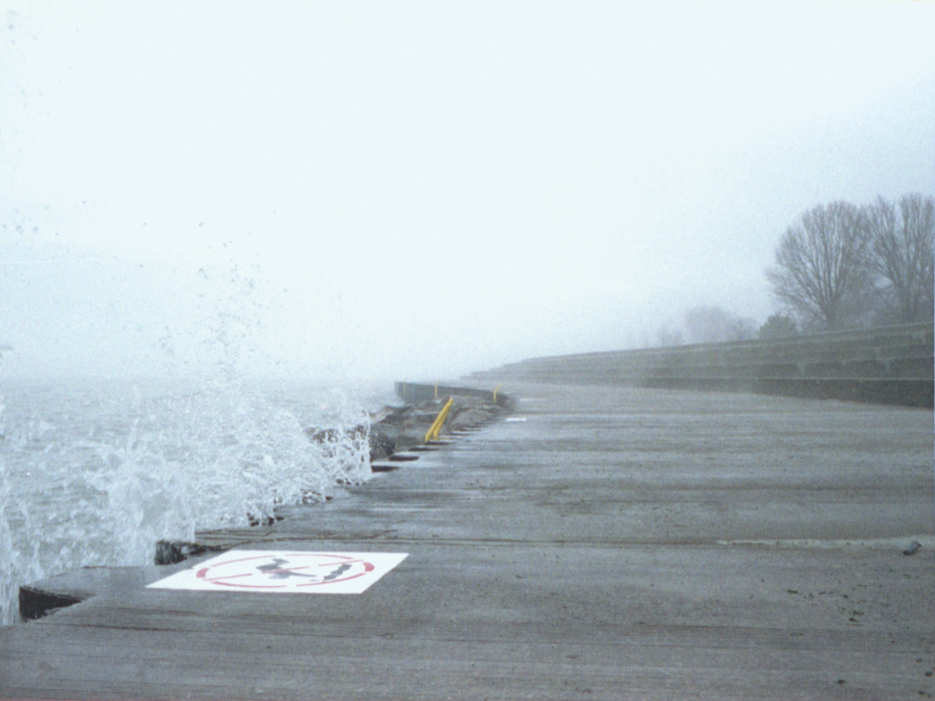 photo of belmont harbor in chicago with waves crashing