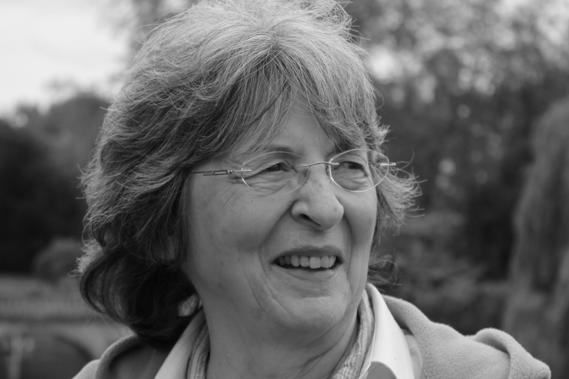 Black and white image of the poet Pattiann Rogers outdoors.
