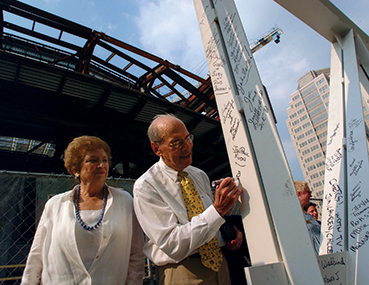 Dr. Benjamin & Marian Schuster signing a steel beam during construction of the Schuster Center