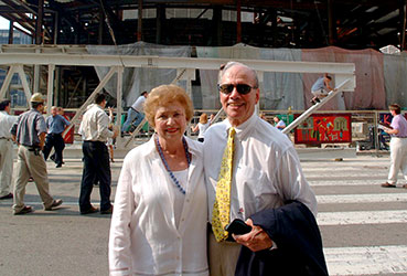 Dr. Benjamin and Marian Schuster standing in front of construction of the Schuster Center