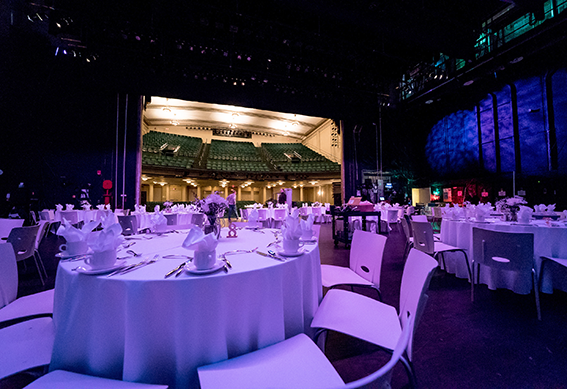 Tables set up for a reception on the stage of the Victoria Theatre.