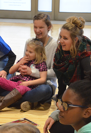 Kids and teens sitting on the floor at the PNC Arts Annex