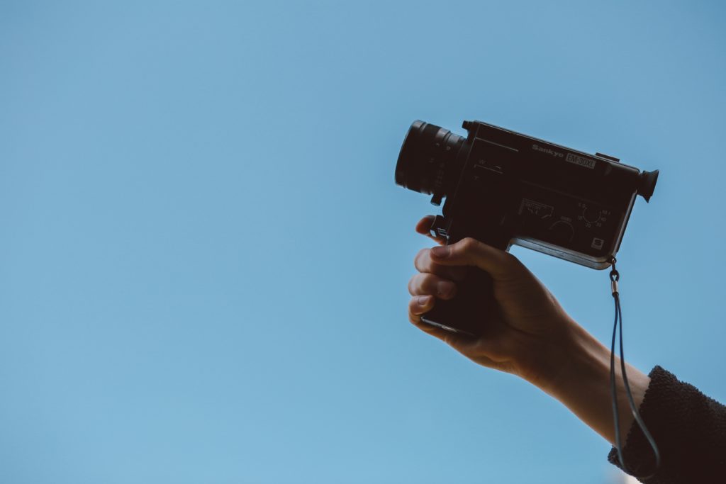 person holding super 8 camera