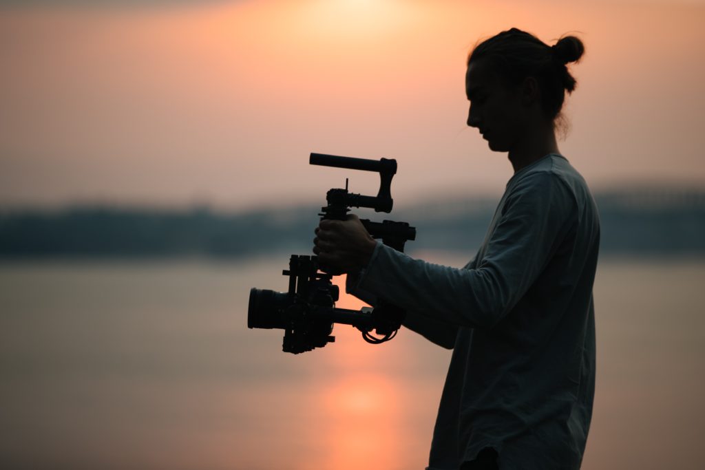 man holding camera with gimbal photography equipment