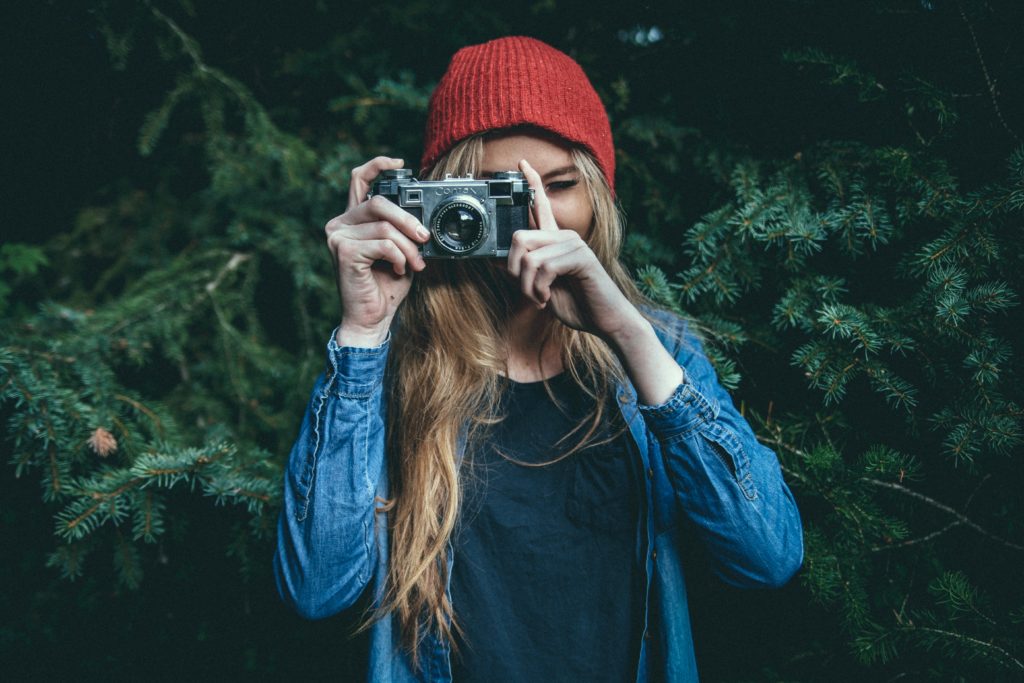 woman taking photo with vintage ebay camera