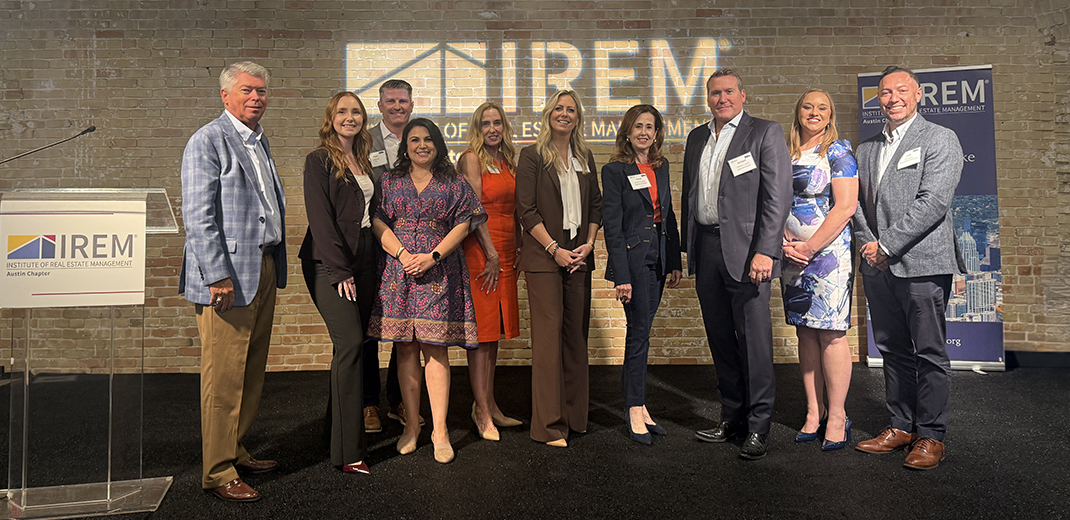 2026 President Mindy Gronbeck, CPM®, CCIM (fifth from left, red dress), joins attendees at TRENDS 2026, hosted by the IREM® Austin chapter.