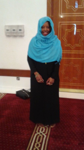 The author wearing a traditional abaya and scarf in a Dubai mosque.