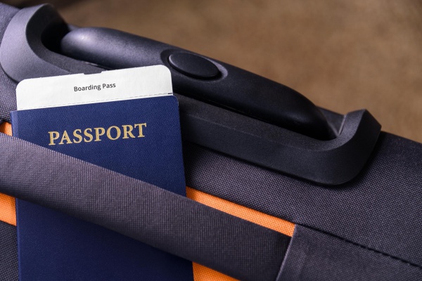 Passport and a boarding pass on a suitcase