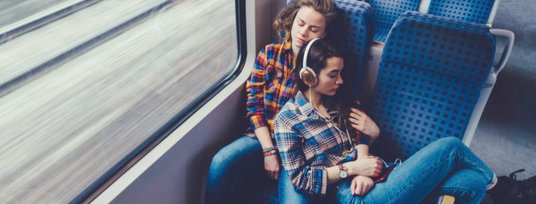 lesbian couple sleeping on a train
