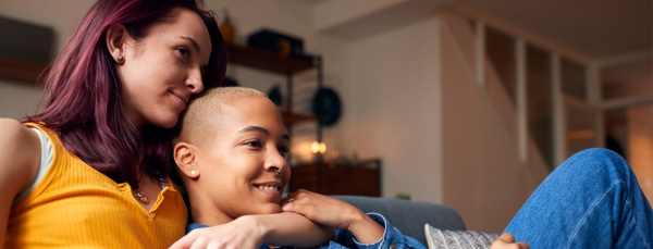 lesbian couple relaxing on a courch