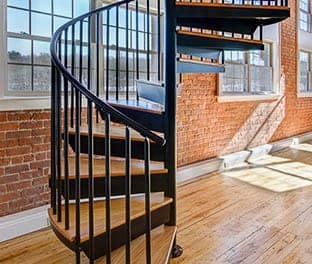 residential condo steel spiral stair with wood accents