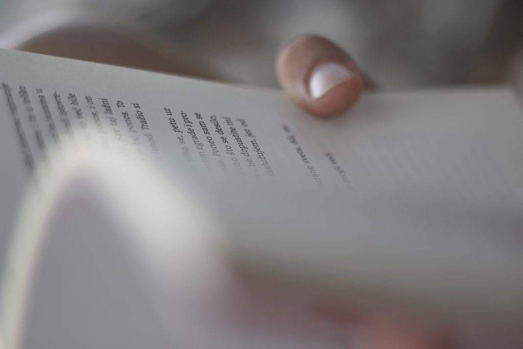 hand holding book Photo by Valentin Salja on Unsplash