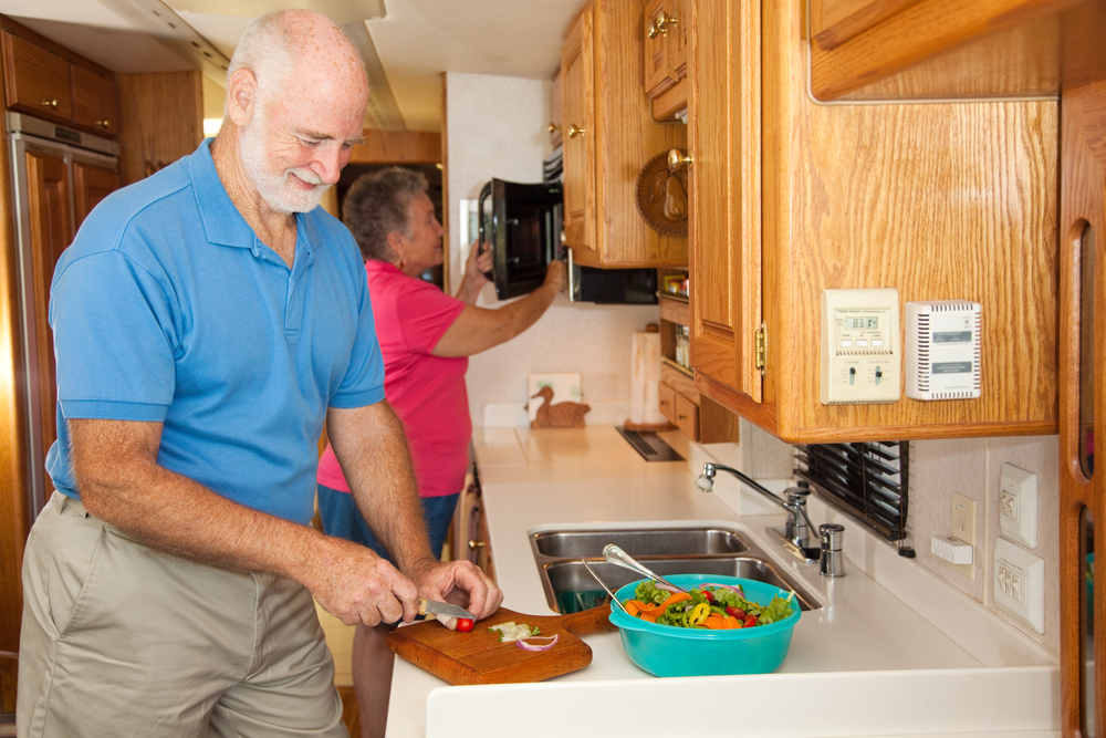 Rv owner making a meal in the RV kitchen 