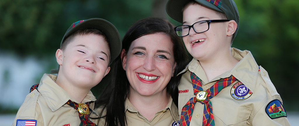 Board The Wilkinson family at a Cub Scout event. Board president. Mom. Mother. Family.