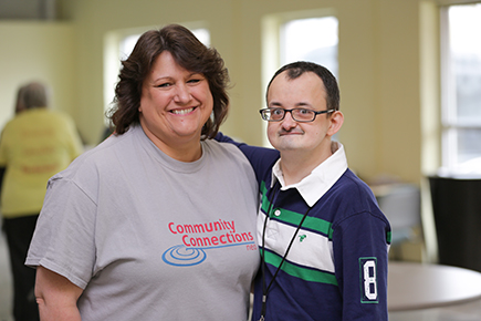 Day program staff member posing with Brad who attends the program