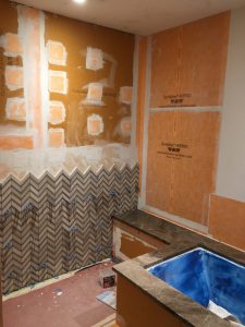 foam building panels were used on open stud walls while waterproof membrane was applied over existing wallboard