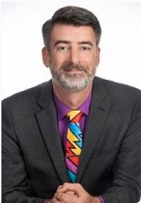 bearded man with colorful tie