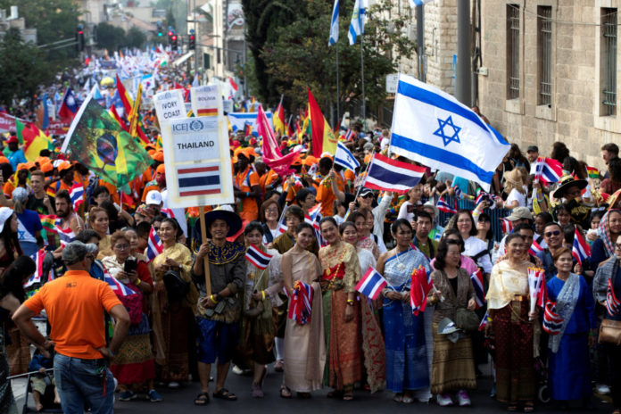 Participants celebrate, together with thousands of foreigners who support Israel, during an annual parade on the Jewish holiday of Sukkot in Jerusalem