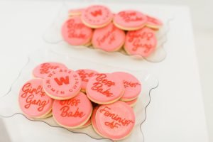 Pink & red custom We Are Women Owned Logo Cookies with some reading
