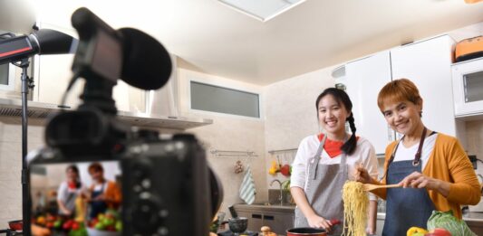 How to Start a YouTube Channel for Cooking Mother and daughter blogger vlogger and online influencer recording video content on healthy food. YouTube channel creation guide.