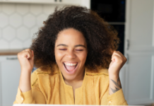 How to Redirect a Subdirectory to Its Own URL Excited woman using a laptop to add a redirect rule on her website