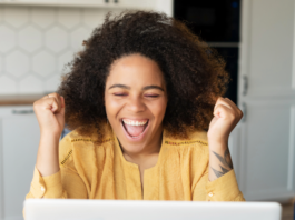 How to Redirect a Subdirectory to Its Own URL Excited woman using a laptop to add a redirect rule on her website