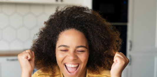 How to Redirect a Subdirectory to Its Own URL Excited woman using a laptop to add a redirect rule on her website