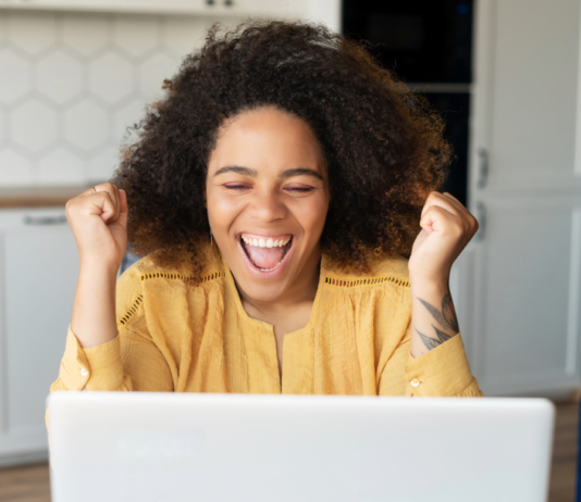 How to Redirect a Subdirectory to Its Own URL Excited woman using a laptop to add a redirect rule on her website