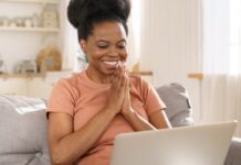 Creative Market Black Friday and Cyber Week Sale Smiling woman looking at Creative Market Black Friday Sale on her laptop