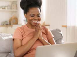 Creative Market Black Friday and Cyber Week Sale Smiling woman looking at Creative Market Black Friday Sale on her laptop