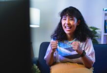 Roku Black Friday Sale Smiling woman watching a Roku subscription on TV she got on sale during Black Friday