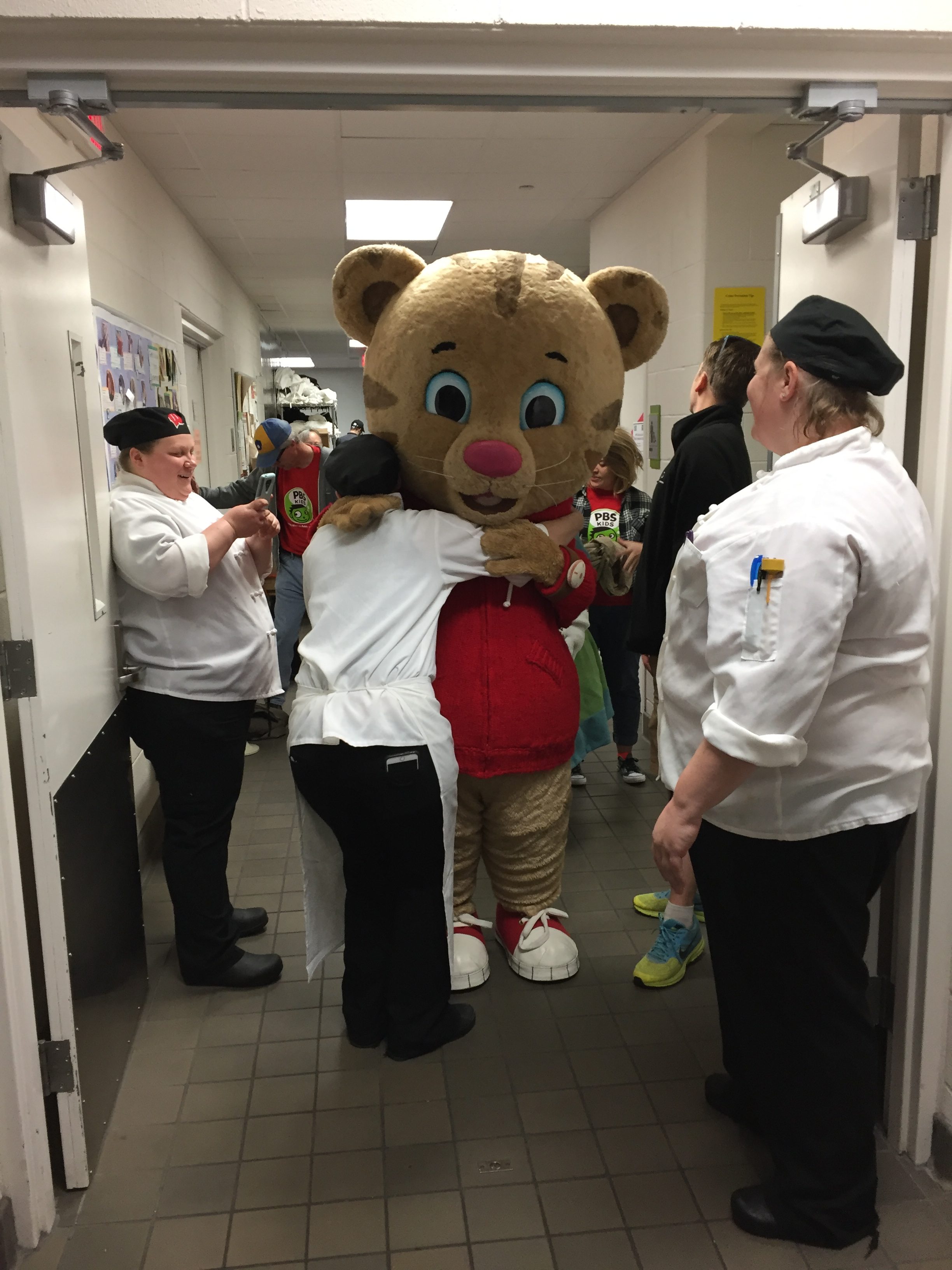 Chefs at Gordon Dining and Event Center hug PBS Kids' Daniel Tiger character