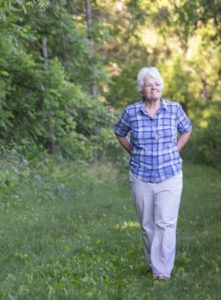 Sister Mary David Walgenbach walks in a wooded area