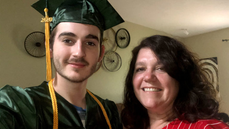 Image of Daniel Croake in Graduation Cap and Gown with mother Shelia Petitjean Image of Daniel Croake in Graduation Cap and Gown with mother Shelia Petitjean