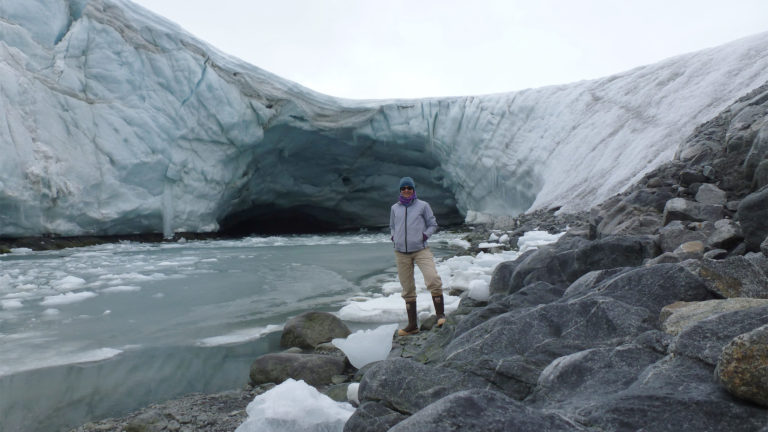 Woman standing in front of glacier Woman standing in front of glacier