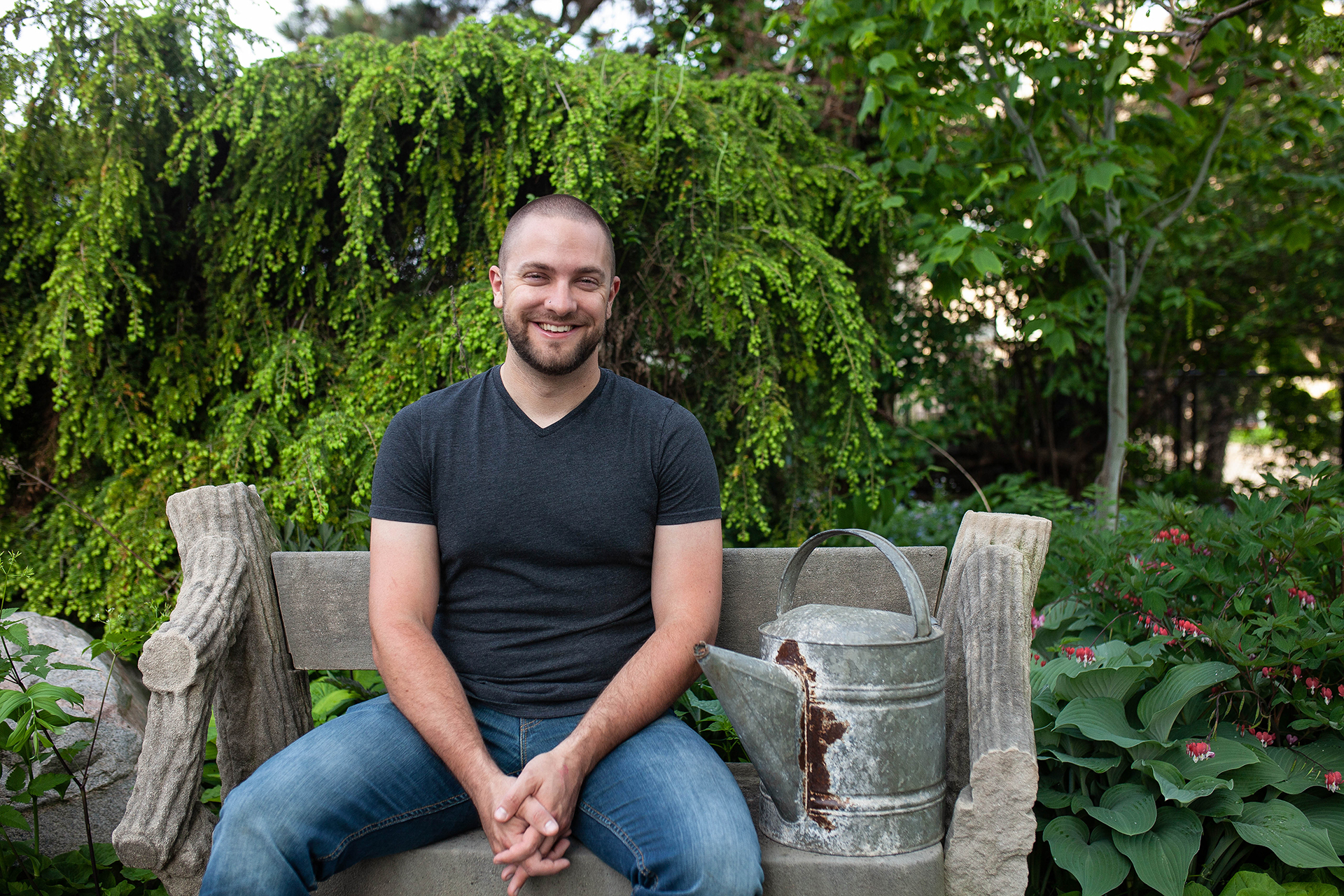 Man sits on a garden bench
