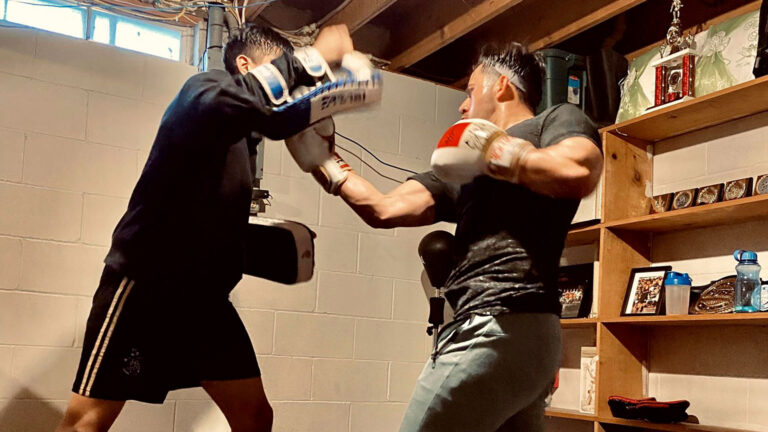 Two fighters training in a basement Two fighters training in a basement