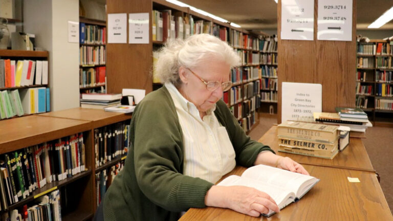 Woman reading a book in a library Woman reading a book in a library