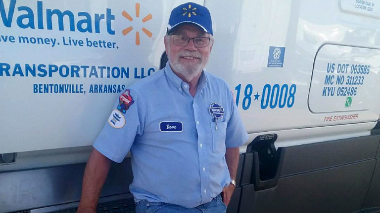 Truck driver standing next to Walmart truck Truck driver standing next to Walmart truck