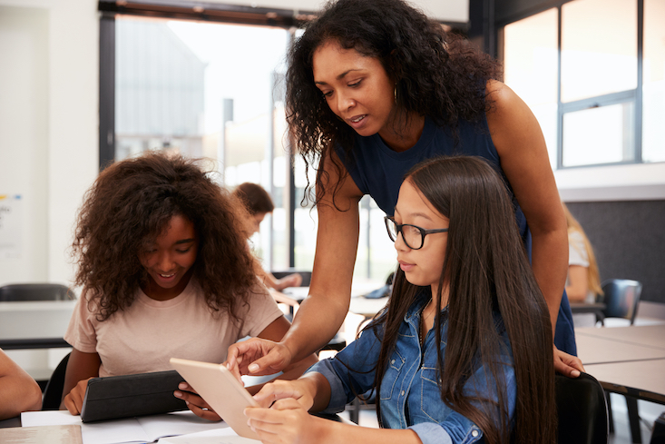 A trauma-informed teacher assisting her students