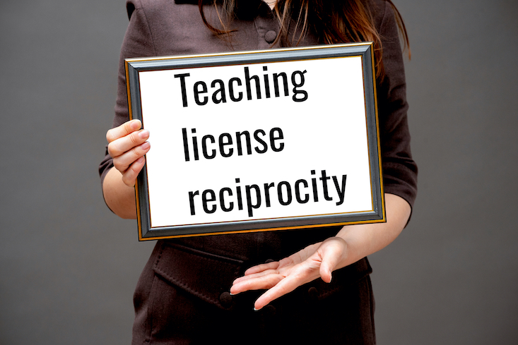 Photo of woman holding up certificate that says "Teaching license reciprocity".