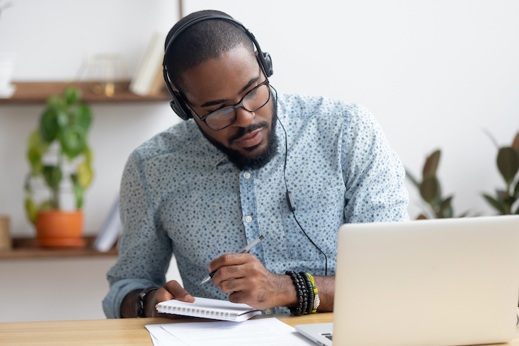 Man on computer researching Teaching license reciprocity.